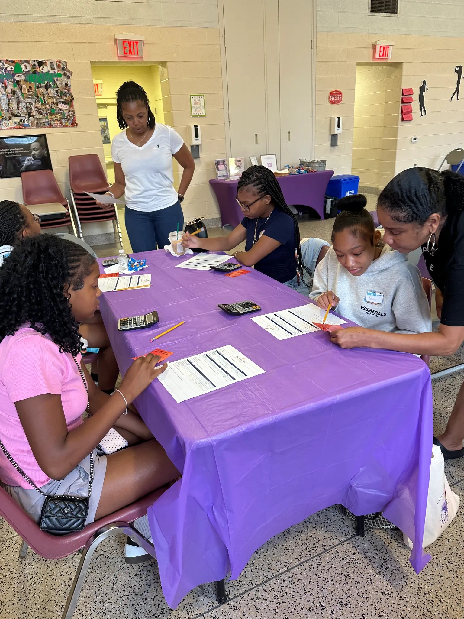 Young people completing a hands-on financial education activity together